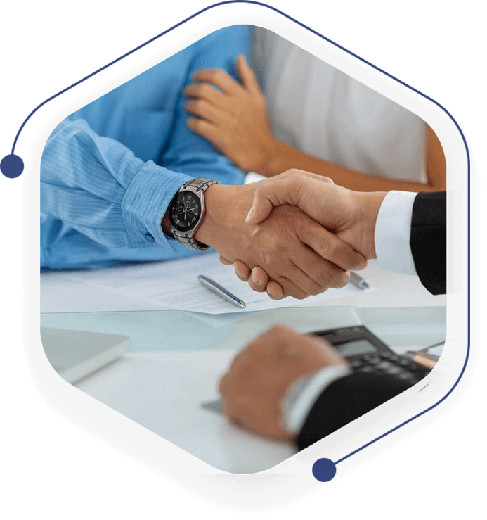 A group of people shaking hands over a table.